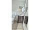 Cozy bathroom with modern vanity, tiled floor, and wainscoting accents at 3009 S Willow Dr, Plant City, FL 33566