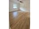 Bright bedroom featuring new flooring, ceiling fan, and two windows at 3009 S Willow Dr, Plant City, FL 33566