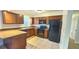 Well-equipped kitchen featuring wood cabinets, modern appliances, and a breakfast bar at 3009 S Willow Dr, Plant City, FL 33566
