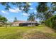 Expansive backyard showcasing a screened-in lanai, pool, and mature landscaping at 3014 Ashland Ter, Clearwater, FL 33761