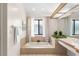 Well-lit bathroom featuring a garden tub, plants, and stylish decor at 3014 Ashland Ter, Clearwater, FL 33761