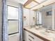 Well-lit bathroom featuring double sinks, decorative curtains, and a bright, airy atmosphere at 3014 Ashland Ter, Clearwater, FL 33761