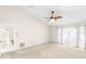 Spacious bedroom featuring plush carpet, fan, and natural light from the door and window at 3014 Ashland Ter, Clearwater, FL 33761