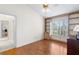Bedroom featuring hardwood floors, custom built-in bookshelves, and a view to the adjacent room at 3014 Ashland Ter, Clearwater, FL 33761