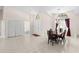 Formal dining area with elegant chandelier, tile floors, double door entry and backyard view at 3014 Ashland Ter, Clearwater, FL 33761