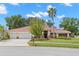 Charming single-story home with a three-car garage and mature landscaping at 3014 Ashland Ter, Clearwater, FL 33761