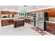 Well-equipped kitchen featuring stainless steel appliances, center island, and tile flooring at 3014 Ashland Ter, Clearwater, FL 33761