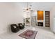 Bright living room boasts tile floors, a ceiling fan, and fireplace with a wood accent wall at 3014 Ashland Ter, Clearwater, FL 33761