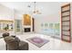 Cozy living room with a fireplace, pool view and sliding glass doors to the outdoor area, and built-in shelves at 3014 Ashland Ter, Clearwater, FL 33761