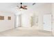 The primary bedroom features neutral carpet, a ceiling fan, and an ensuite bathroom at 3014 Ashland Ter, Clearwater, FL 33761