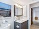 This bathroom features a granite-topped vanity, modern lighting, a window with ocean views, and tile floors at 3182 Windmoor N Dr, Palm Harbor, FL 34685