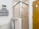 Compact bathroom with a glass enclosed shower and stacked towel rack at 3182 Windmoor N Dr, Palm Harbor, FL 34685