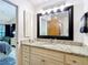 Bathroom featuring granite countertops and a door to the stand up shower can be seen in the mirror at 3182 Windmoor N Dr, Palm Harbor, FL 34685