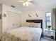 Comfortable bedroom with large closet and floral decorations, lit by wall sconces at 3182 Windmoor N Dr, Palm Harbor, FL 34685