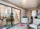 Bright Florida room with seating and large sliding windows at 3182 Windmoor N Dr, Palm Harbor, FL 34685