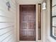 Solid wood front door with sidelight and decorative butterfly accent at 3182 Windmoor N Dr, Palm Harbor, FL 34685