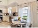 Charming kitchen with stainless steel appliances and breakfast nook featuring a marble table at 3182 Windmoor N Dr, Palm Harbor, FL 34685