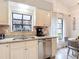 Updated kitchen with white cabinets, stainless appliances, and a breakfast nook with large windows at 3182 Windmoor N Dr, Palm Harbor, FL 34685