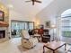Inviting living room featuring a stone fireplace and comfortable seating at 3182 Windmoor N Dr, Palm Harbor, FL 34685