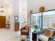 Bright living area with high ceilings, tile floors, and a sunroom through sliding glass doors at 3182 Windmoor N Dr, Palm Harbor, FL 34685