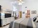 Spacious main bedroom with high ceilings, updated fan, dresser with television, and ensuite bathroom at 3182 Windmoor N Dr, Palm Harbor, FL 34685