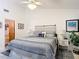 Bright main bedroom with light walls, ceiling fan, and decorative pillows on the bed at 3182 Windmoor N Dr, Palm Harbor, FL 34685