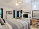 Spacious bedroom with vaulted ceilings, dresser with television, vanity area, and a comfortable bed at 3182 Windmoor N Dr, Palm Harbor, FL 34685