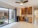 Bright office space with built-in shelves, desk, a sliding glass door to the outside, and tiled flooring at 3182 Windmoor N Dr, Palm Harbor, FL 34685