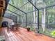 Relaxing screened patio for outdoor gatherings and dining with a view of nature at 3182 Windmoor N Dr, Palm Harbor, FL 34685