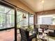Inviting screened porch with beautiful views of the surrounding wooded area at 3182 Windmoor N Dr, Palm Harbor, FL 34685