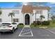 White condo building exterior with neat landscaping, parking, and brown roof at 343 S Mcmullen Booth Rd # 151, Clearwater, FL 33759