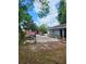Large backyard with mature trees, picnic table, and separate shed at 3607 N 13Th St, Tampa, FL 33605