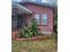 Close up of a brick home's exterior with lush tropical plants in the front yard at 3607 N 13Th St, Tampa, FL 33605