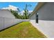 A fenced backyard featuring a well maintained lawn and the exterior of the home at 37673 Dixie Ave, Dade City, FL 33525