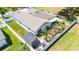 An aerial view of the backyard featuring white vinyl fencing, a pergola, a shed, and tropical landscaping at 37673 Dixie Ave, Dade City, FL 33525