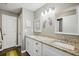 Modern bathroom with double sinks, granite countertops, and wood-look flooring at 37673 Dixie Ave, Dade City, FL 33525