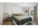 Comfortable bedroom with wood-look floors, a large window, and elegant décor at 37673 Dixie Ave, Dade City, FL 33525