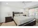 Comfortable bedroom with a large bed, nightstands, and a window view at 37673 Dixie Ave, Dade City, FL 33525