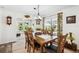 Bright dining area with wood table, seating for six, and view to the backyard at 37673 Dixie Ave, Dade City, FL 33525