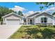 Charming single-Gathering home with well-maintained lawn, beautiful landscaping, and a two-car garage at 37673 Dixie Ave, Dade City, FL 33525