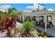 Charming single-story home featuring a covered patio and lush landscaping, enhancing its curb appeal and outdoor living space at 37673 Dixie Ave, Dade City, FL 33525