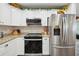 Modern kitchen features stainless steel appliances, granite countertops, and white cabinetry at 37673 Dixie Ave, Dade City, FL 33525