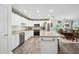 Open-concept kitchen with white cabinets and stainless steel appliances at 37673 Dixie Ave, Dade City, FL 33525