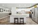 Modern kitchen with white cabinets, granite countertops, stainless steel appliances, and a spacious island at 37673 Dixie Ave, Dade City, FL 33525