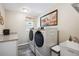Laundry room with modern washer and dryer, granite countertops, and a bright window at 37673 Dixie Ave, Dade City, FL 33525