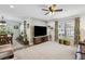 Bright living room featuring a large TV and views into the dining area at 37673 Dixie Ave, Dade City, FL 33525