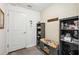Mudroom with a storage bench and colorful cushion, wood look floors, and storage shelves at 37673 Dixie Ave, Dade City, FL 33525