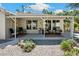 Covered patio with ample seating, perfect for enjoying the outdoors, complemented by mature landscaping and a tranquil backyard setting at 37673 Dixie Ave, Dade City, FL 33525