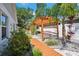 Inviting backyard featuring a wooden pergola and lush landscaping offering serene outdoor ambiance and relaxation at 37673 Dixie Ave, Dade City, FL 33525