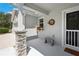 Inviting front porch with stone pillar, wreath, flower box, and a bench at 37673 Dixie Ave, Dade City, FL 33525